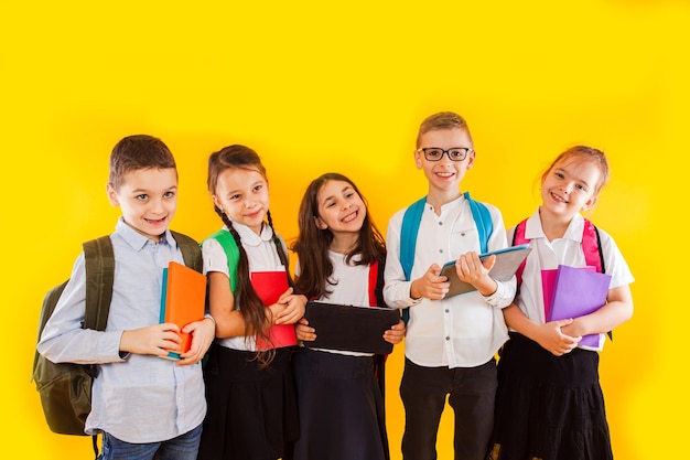 Group of classmates reading books and ebooks