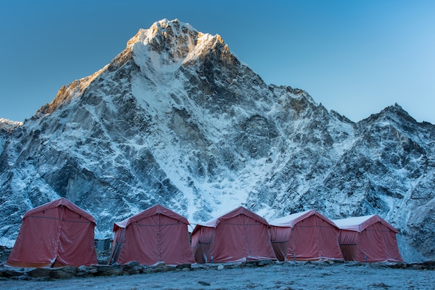 Group of climbers bright tents on the khumbu glacier of everest base camp with colorful pr