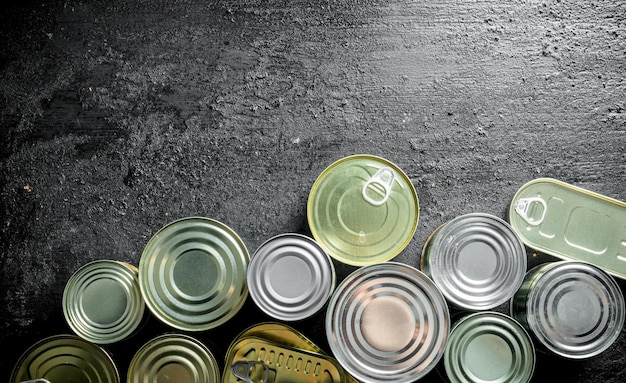 Group of closed metal cans of canned food