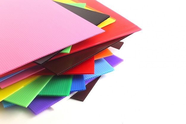 Group of colorful corrugated plastic sheets on white