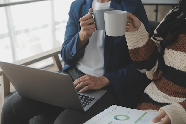 Group of confident business people point to graphs and charts to analyze market data balance sheet account net profit to plan new sales strategies to increase production capacity