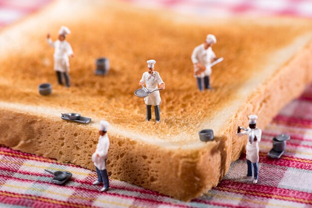 group of cooks or chefs on a slice of white toast