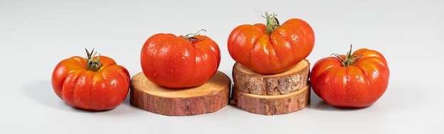 A group of Costoluto big tomatoes on a grey background space for text
