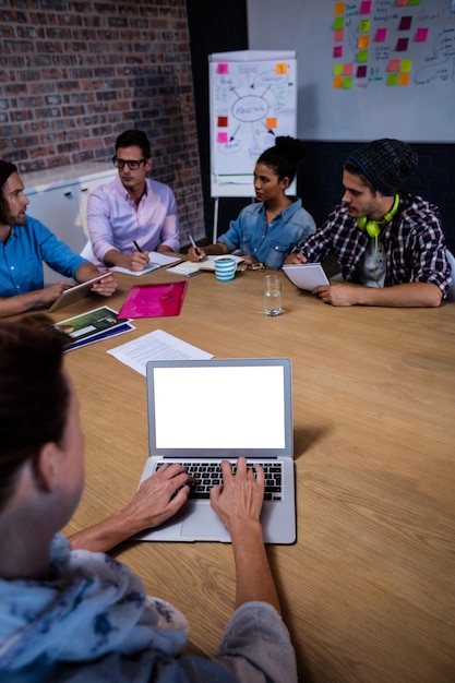 Photo group of coworkers during meeting and laptop