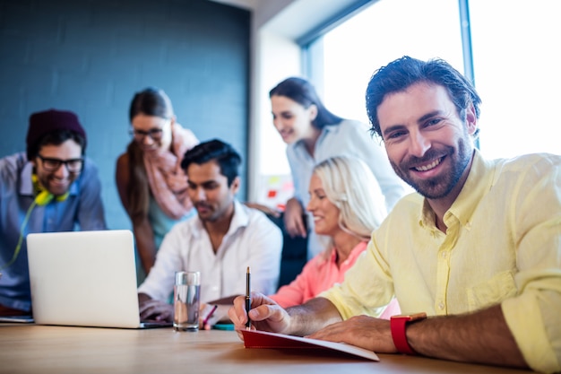 Group of coworkers using a laptop