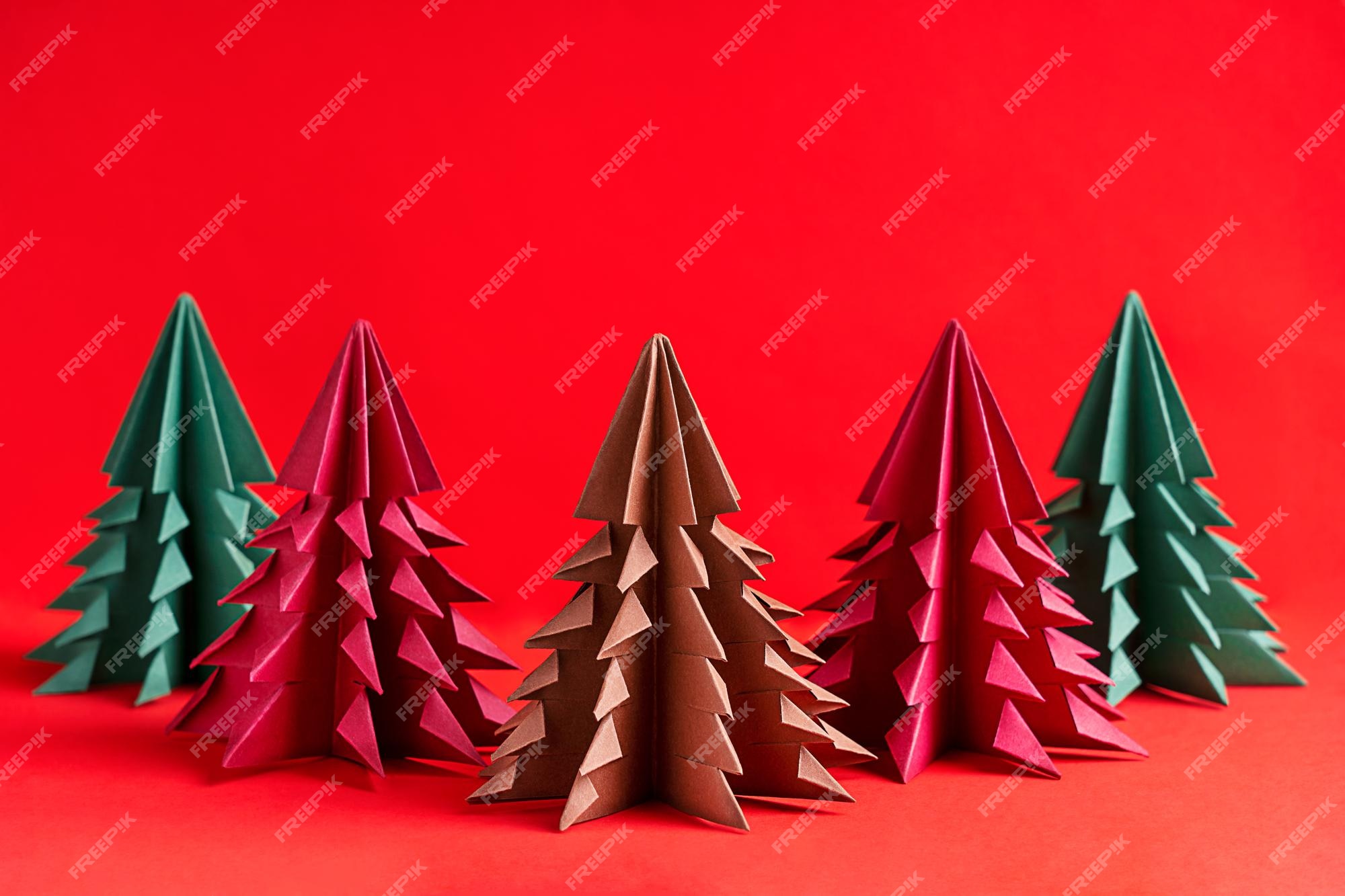 Premium Photo | Group of crafted christmas fir trees origami made ...