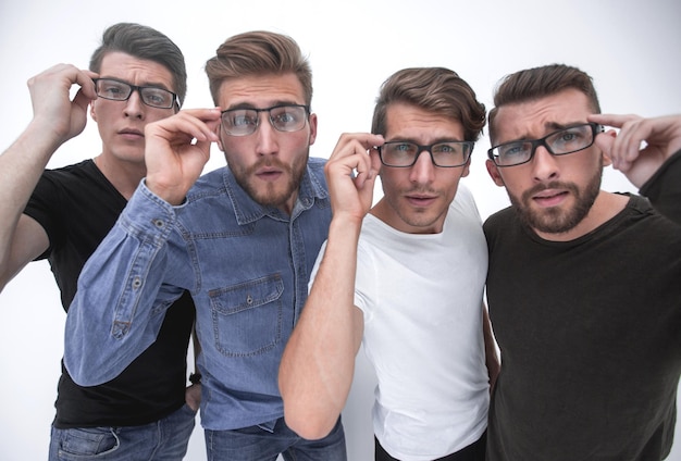 Group of creative young men looking at you through glasses