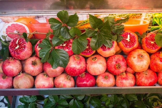 Group of cut red pomegranate fruit on display at market