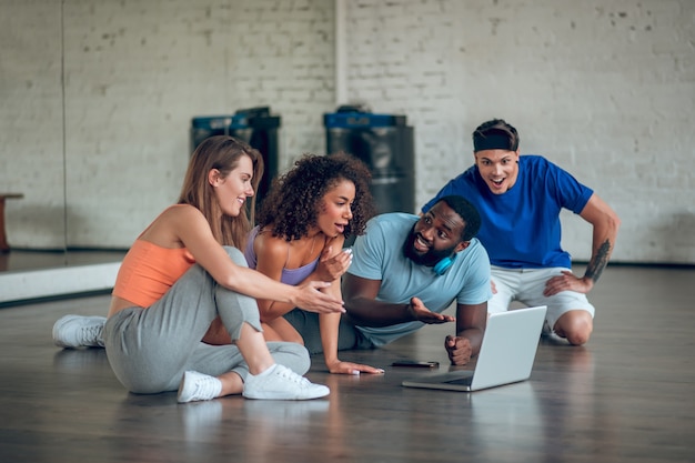 group of dancers watching a dancing video in the class