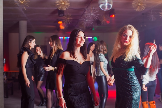 Group of dancing young people enjoying night in club