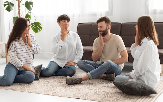 Photo group of deaf people communicating through sign language