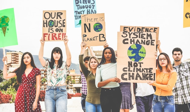 Group of demonstrators on road, young people from different culture and race fight for climate change. Global warming and environment concept