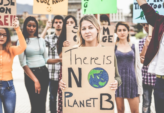 Group of demonstrators on road, young people from different culture and race fight for climate change