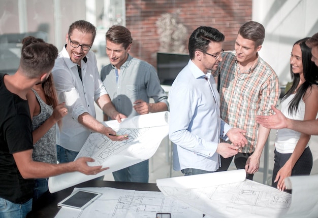 Group of designers and architects discussing new sketches