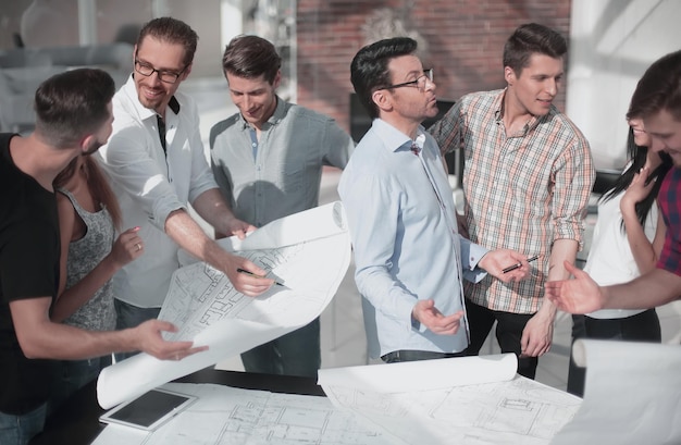 Group of designers and architects discussing new sketches