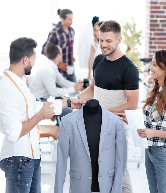 Group of designers discuss men's suit in the Studio