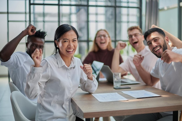 group of different business people celebrating victory while