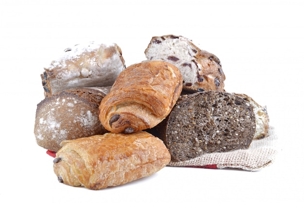 Group of different variety of bread and pastry on white background