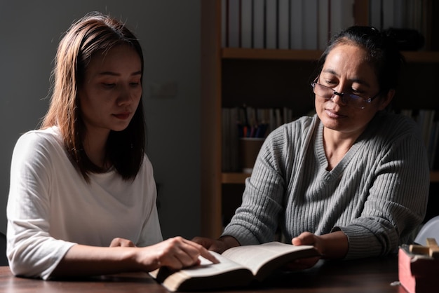 Group of different women praying together Christians and Bible study concept