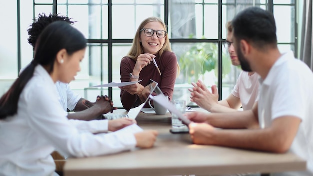 Group of diverse business people sitting together at a table