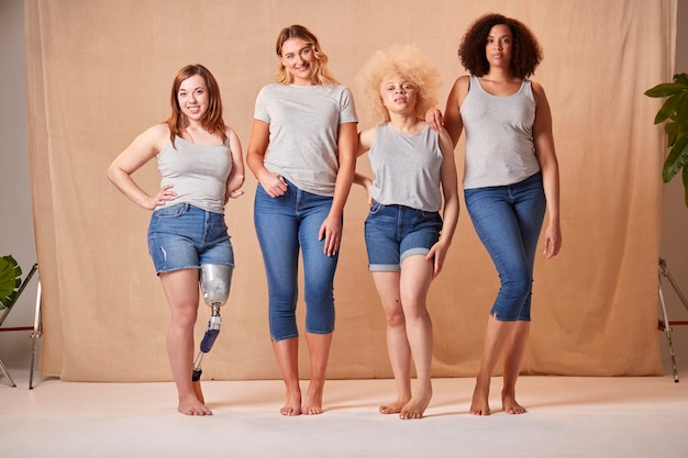 Photo group of diverse casually dressed women friends one with prosthetic limb promoting body positivity