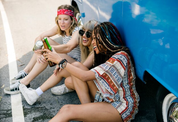 Group of Diverse Friends Drinking Beers Alcohol Together by the Van