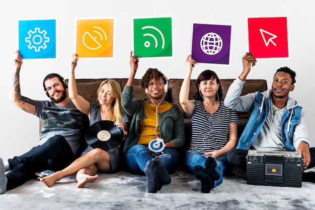 Group of diverse friends holding technology icons