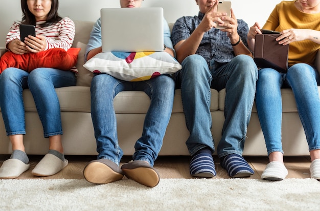 Group of diverse friends using digital devices