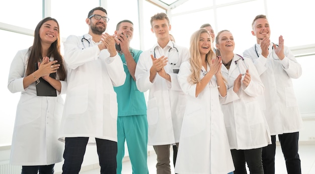 Group of diverse medical staff members applauding together