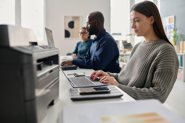 Group of diverse millennials working in office