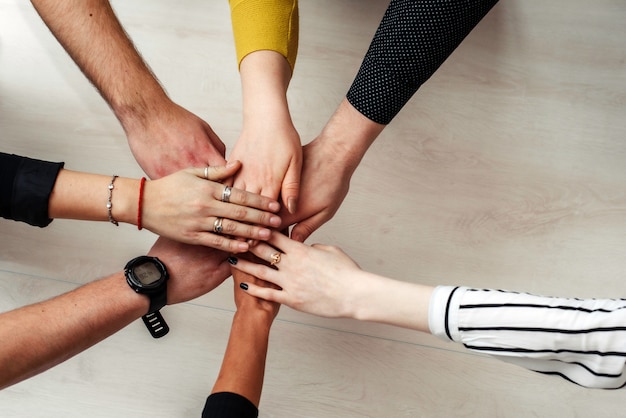 Group of Diverse Multiethnic People Teamwork Concept. Teamwork Togetherness Collaboration Concept. Hands of office workers in a circle