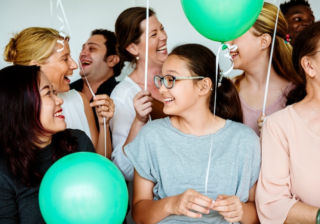 Photo group of diverse people holding balloons cheerful