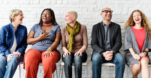 A group of diverse people is sitting together