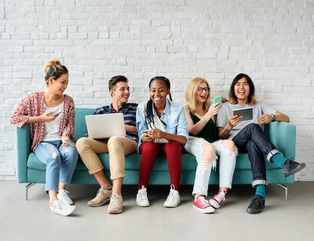 A group of diverse people is using digital devices