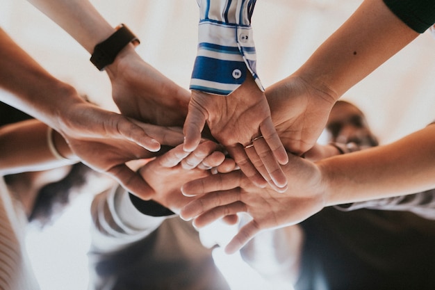 Group of diverse people stacking hands in the middle