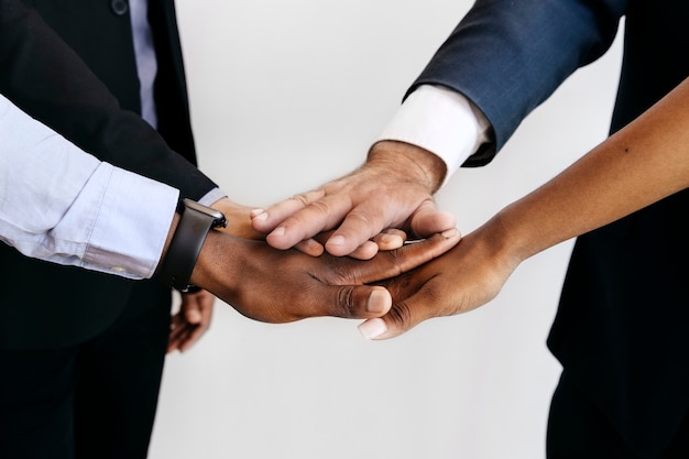 Group of diverse people stacking hands in the middle