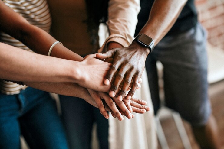 Photo group of diverse people stacking hands in the middle