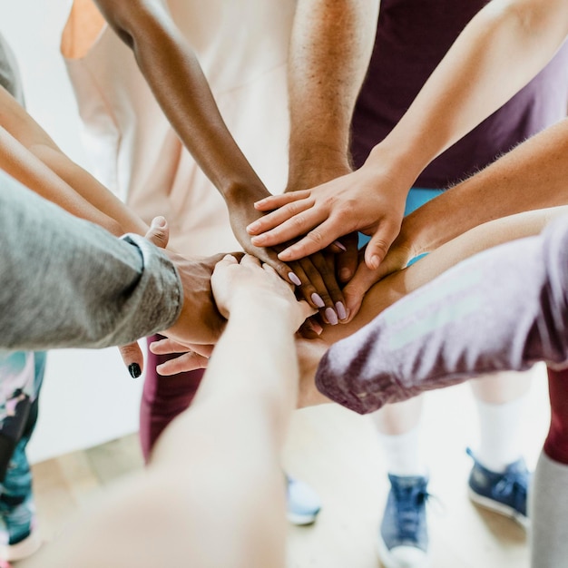 Group of diverse people stacking hands in the middle