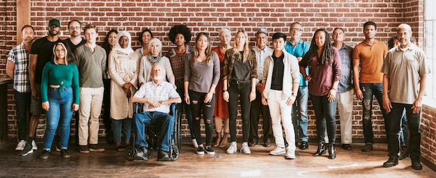 Group of diverse people standing in front of a brick wall