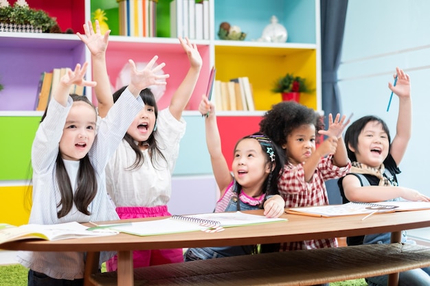 Photo group diversity kids studying at school rising hands and enjoy in classroom kids education concept