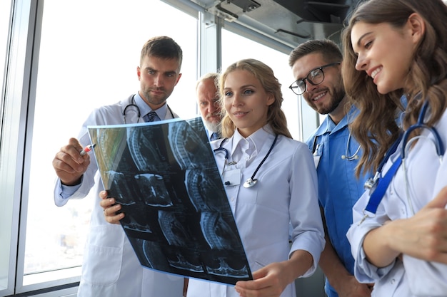 Group of doctors checking x-rays in a hospital.