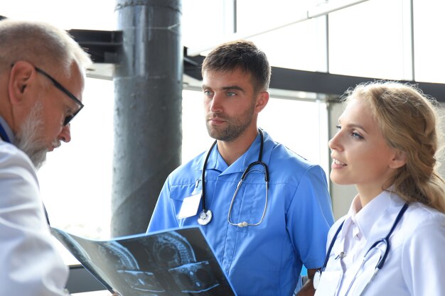 Group of doctors checking x-rays in a hospital.