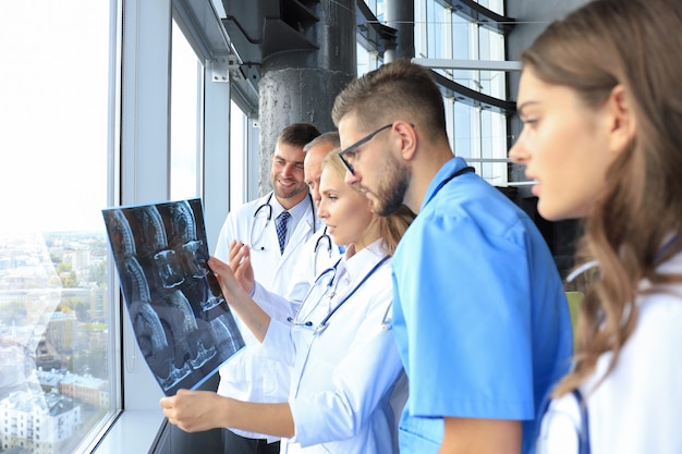 Group of doctors checking x-rays in a hospital.