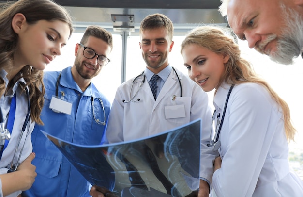 Group of doctors checking x-rays in a hospital.