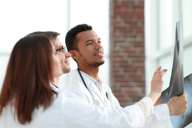 Group of doctors discussing the patient's x-ray after surgery . the concept of health