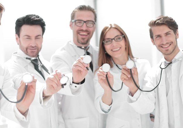 Group of doctors hold their stethoscopes the concept of professionalism