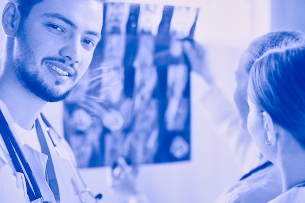 Group of doctors and nurses looking at Xray