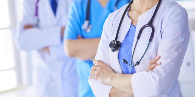 Group of doctors and nurses standing in the hospital accident\
and emergency department