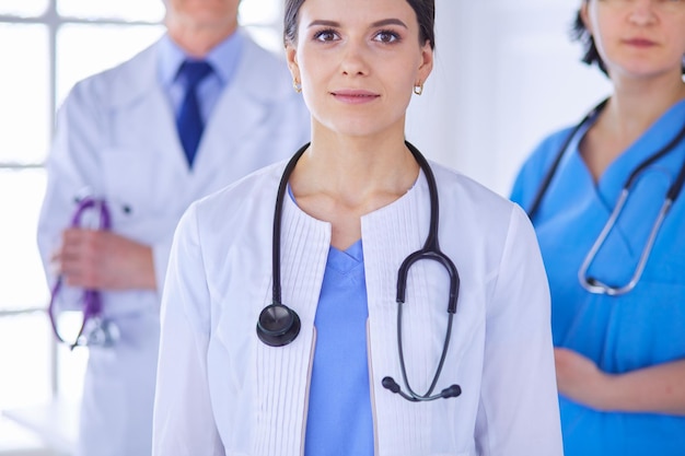 Group of doctors and nurses standing in a hospital room