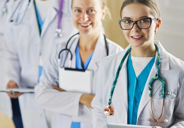 Group of doctors and nurses standing in the hospital room